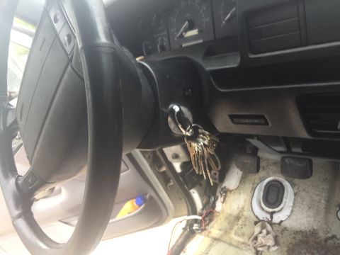 1996 Ford Bronco - Interior view of a vehicle's dashboard, steering wheel, and ignition with keys.