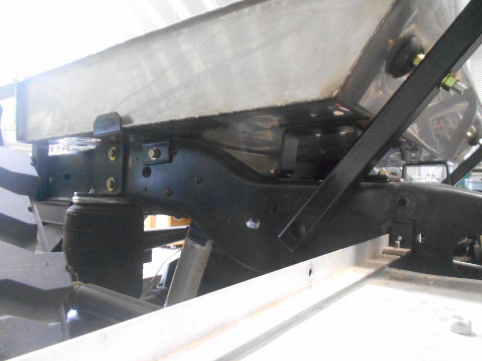 Underside view of a vehicle chassis with a large tank, air suspension, and frame components.