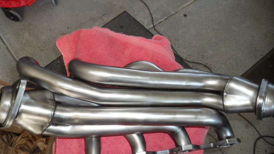 Polished stainless steel exhaust headers for a V8 engine