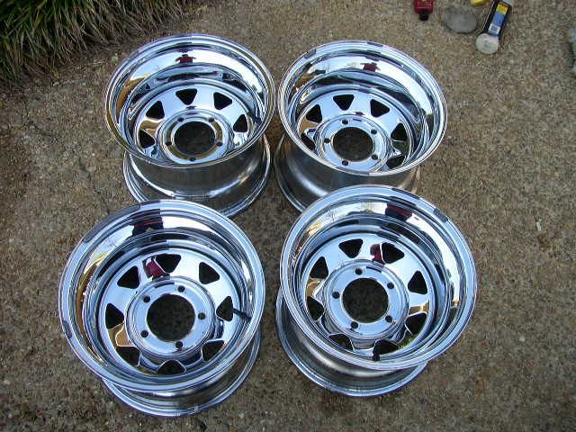 four shiny chrome wheels with five lug nut holes