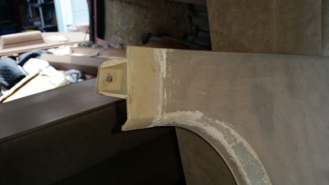 1985 Ford Bronco - A close-up view of a vehicle's fender or body panel, showing a beige primer or base coat with some areas of sanding and repair work visible…