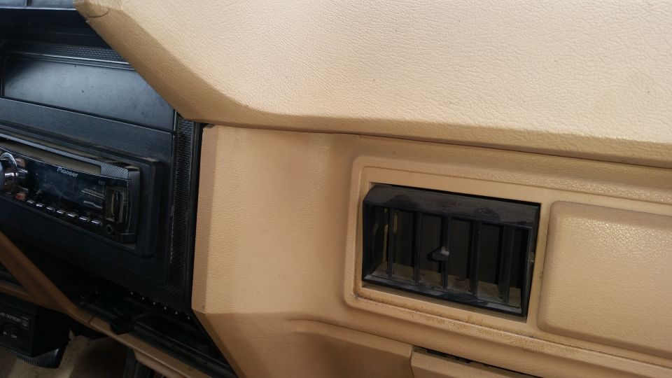 Close-up of a car dashboard showing a Pioneer stereo and an air vent.