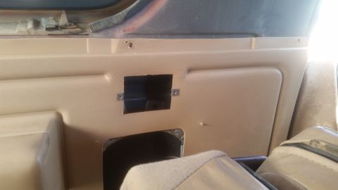 1985 Ford Bronco - This is a close-up interior shot of a tan panel in what appears to be a Ford Bronco. A rectangular cutout is visible in the panel, revealin…