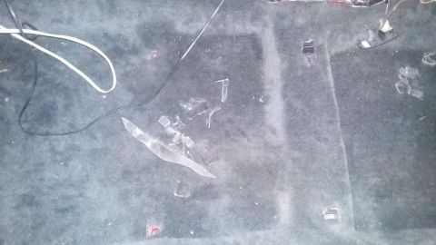 2000 Pontiac Grand Prix - Car interior floor shows debris including broken glass and wires.