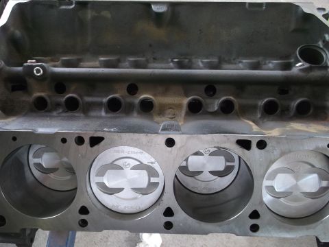 1969 Ford Mustang - Engine block with pistons installed. Text is visible on the pistons, but the vehicle year is not identifiable.