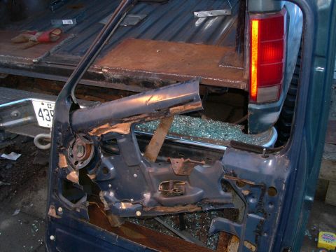 1986 Ford Bronco - Damage to the door frame and shattered glass on a 1986 Ford Bronco.