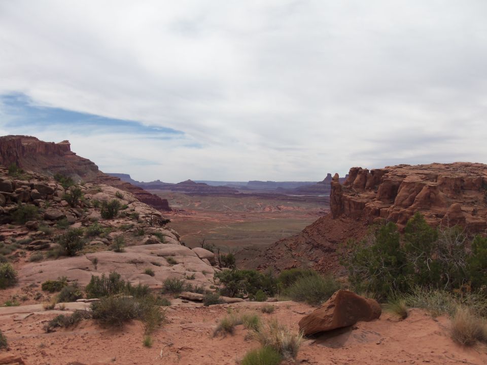 Desert landscape with red rock formations and a cloudy sky