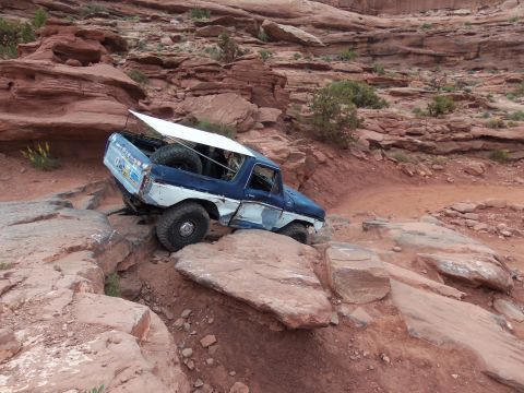1984 Ford Bronco - This modified Ford Bronco navigates a challenging rocky terrain, its off-road capabilities.
