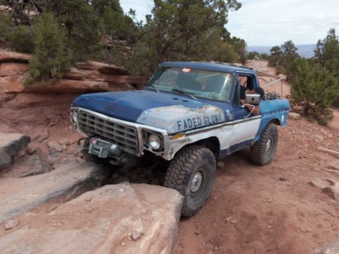 1984 Ford Bronco - This modified pickup truck, possibly a 1978 Ford F-Series, tackles a challenging off-road course.