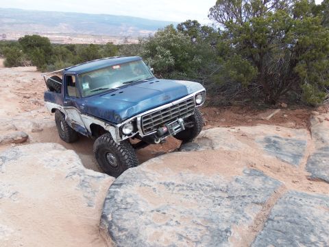 1984 Ford Bronco - This modified Ford Bronco navigates a challenging rocky trail, its off-road capabilities.