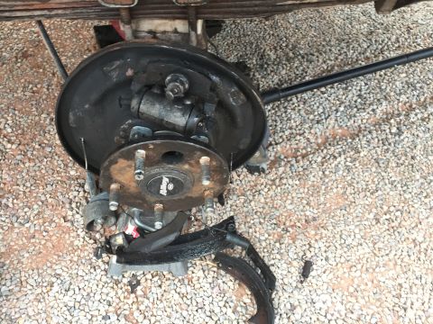 1984 Ford Bronco - Drum brake assembly removed for service, showing internal components and brake shoes.