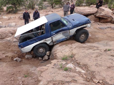 1984 Ford Bronco - This modified Ford Bronco is navigating a difficult rocky terrain.