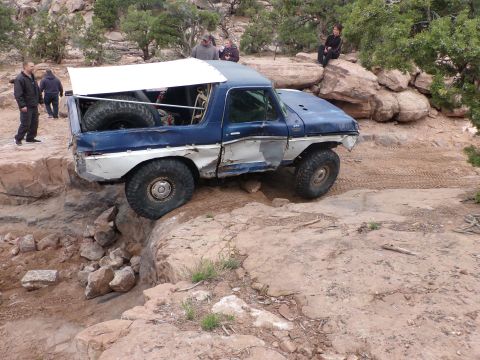 1984 Ford Bronco - This modified SUV navigates a challenging rocky trail, its off-road capabilities.