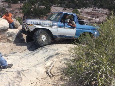 1984 Ford Bronco - This Ford truck, likely from the 1970s, is shown off-roading on a rocky trail.
