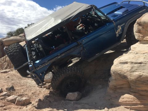 1984 Ford Bronco - This modified SUV is navigating a difficult rocky terrain, its off-road capabilities.