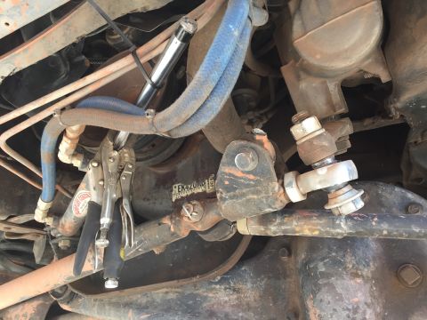 1984 Ford Bronco - A close-up view of the steering linkage and associated components on a vehicle.