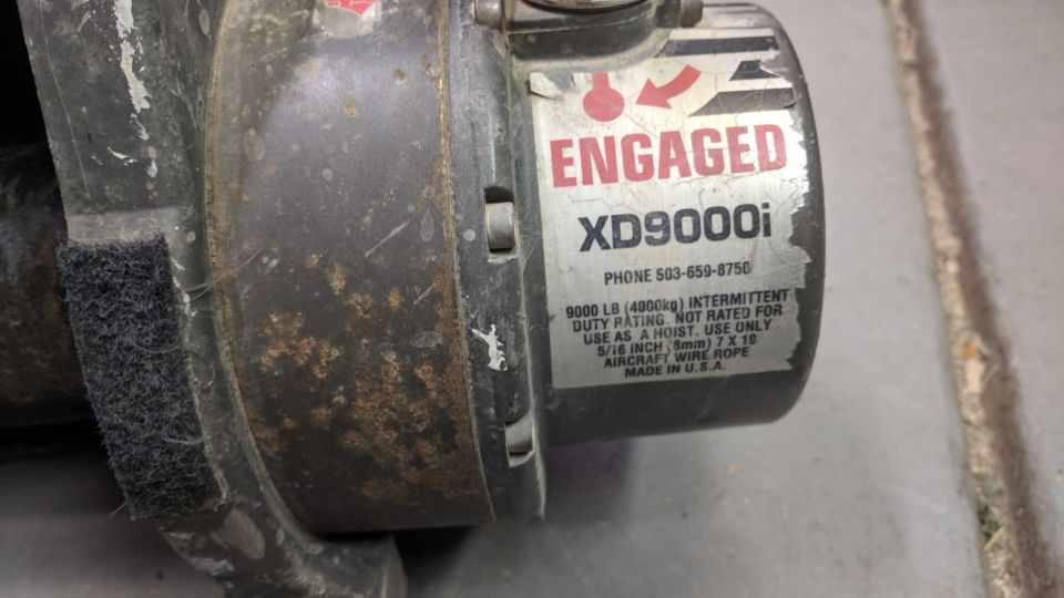 Winch with label showing 'ENGAGED XD9000i' and specs for 9000 lb capacity