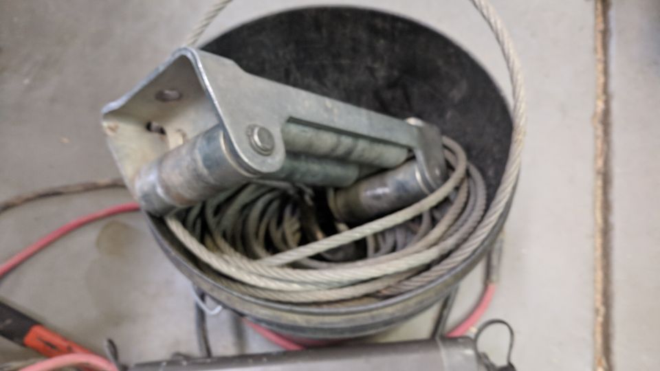 Winch with coiled cable and red wire, close-up