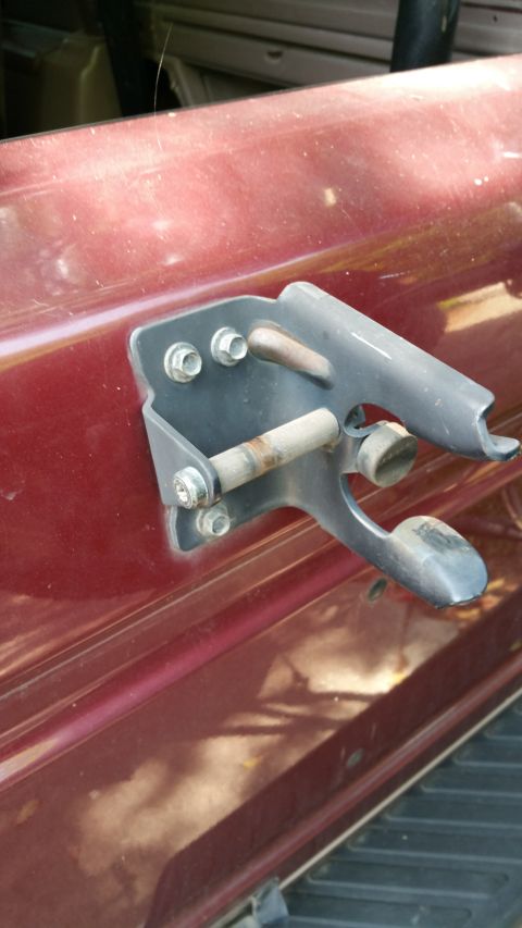 1996 Ford Bronco - Close-up of the rear tire carrier mount on a 1996 Ford Bronco.