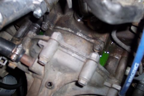 1995 Ford Bronco - Green coolant is leaking from a hose connection on the engine block.