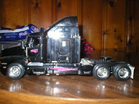 1989 Ford Crown Victoria - Model semi-truck with custom pink flame graphics and studded detailing.