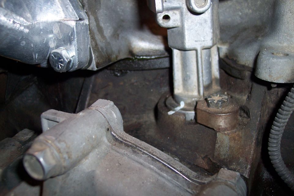 Close-up of engine parts with bolts and wiring