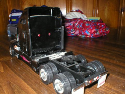 1989 Ford Crown Victoria - Model semi-truck displayed on a wooden surface with blankets in the background.