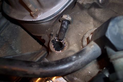 1995 Ford Bronco - Broken bolt lodged in engine block, indicating potential mechanical issue.