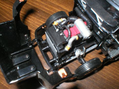 1989 Ford Crown Victoria - Close-up of a model car's engine bay, showing intricate details of the engine components and chassis.