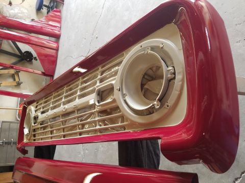 1968 Ford Bronco - Front grille and fender assembly of a 1968 Ford Bronco, undergoing painting.
