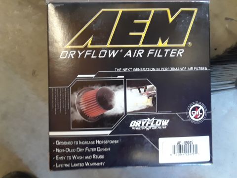 1999 Ford E250 - Box for an AEM Dryflow Hybrid Air Filter, showing product details and a part number.