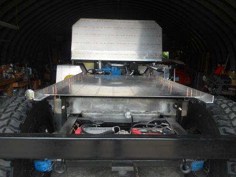 1992 Ford Bronco - This custom truck bed features a large metal enclosure and exposed engine parts, suggesting a unique build.