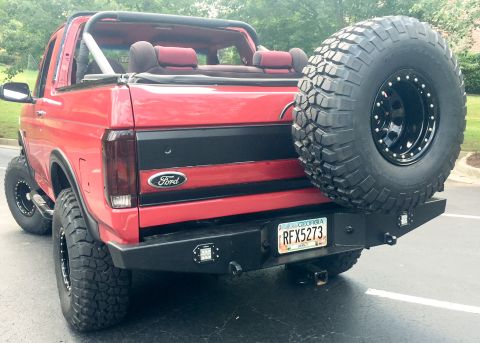 1994 Ford Bronco - Rear view of a red 1994 Ford Bronco, a spare tire mounted on a custom bumper and a Georgia license plate.