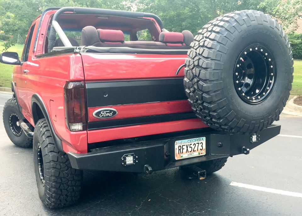 Red 1994 Ford Bronco rear view with spare tire on bumper