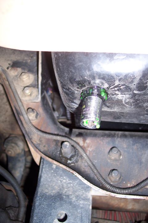 1995 Ford Bronco - Leaking fitting on vehicle undercarriage, green fluid visible.