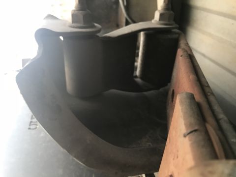 1997 Dodge 3500 - Detail of a vehicle's rear suspension components, showing rust and wear on metal parts.