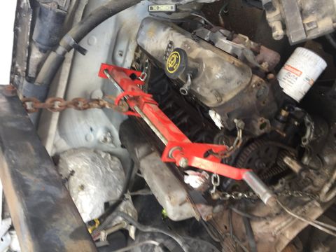 1996 Ford Bronco - Engine bay with engine hoist and chains, likely during a swap or repair. No clear vehicle identification visible.