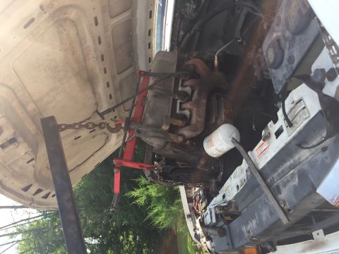 1996 Ford Bronco - Engine removal in progress, showing the engine hoist and various engine components.