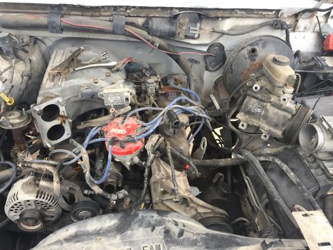 1996 Ford Bronco - Engine bay components visible, including distributor, alternator, and brake booster.