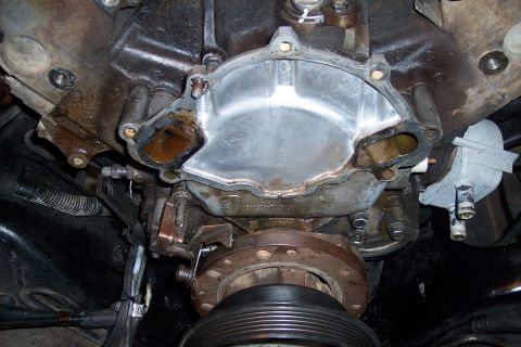 1995 Ford Bronco - Close-up view of an engine's water pump housing area after removal.