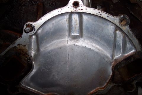 1995 Ford Bronco - This engine timing cover has a visible crack running down its center.