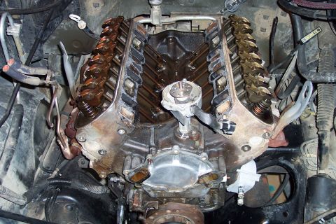 1995 Ford Bronco - Disassembled V8 engine showing internal components like rocker arms and pushrods.