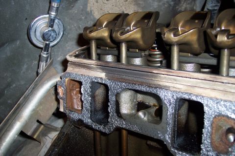 1995 Ford Bronco - Close-up view of an engine's cylinder head, showing internal components and gasket material.