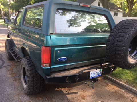 1996 Ford Bronco - Rear view of a 1996 Ford Bronco with a spare tire on the back and an aftermarket bumper.