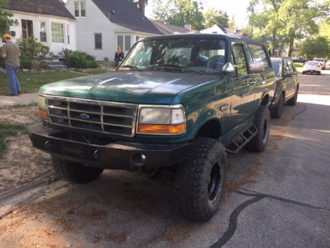 1996 Ford Bronco - This lifted Ford Bronco features an aftermarket bumper and is parked on a residential street.