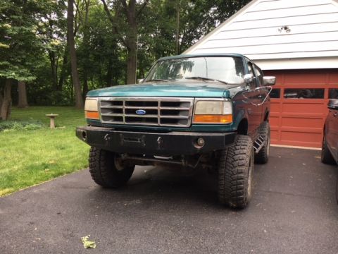 1996 Ford Bronco - This 1996 Ford Bronco is parked in front of a garage door.
