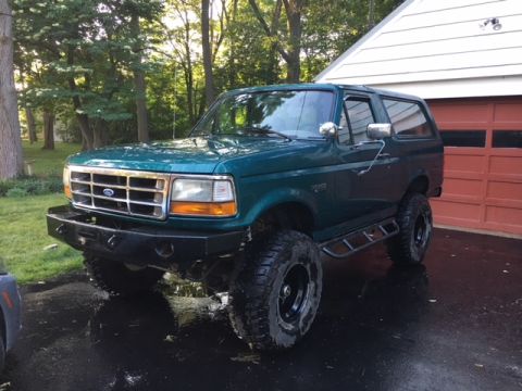 1996 Ford Bronco - This 1996 Ford Bronco is shown from a three-quarter front angle, parked in a driveway.