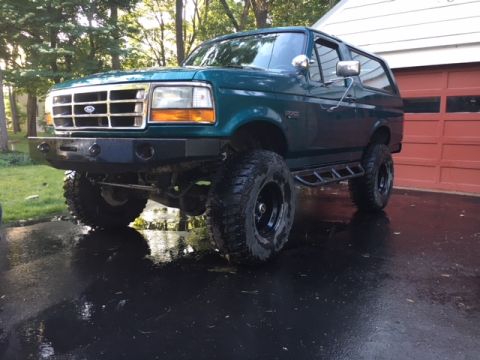 1996 Ford Bronco - This 1996 Ford Bronco features an aggressive aftermarket bumper and oversized tires, giving it a stance.