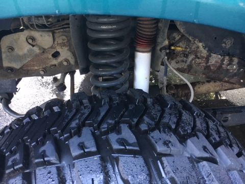 1996 Ford Bronco - This image shows the suspension and tire of a vehicle, not a specific model year.