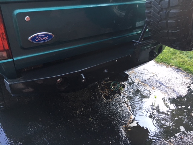 Green 1996 Ford Bronco rear bumper with spare tire mount and Ford badge